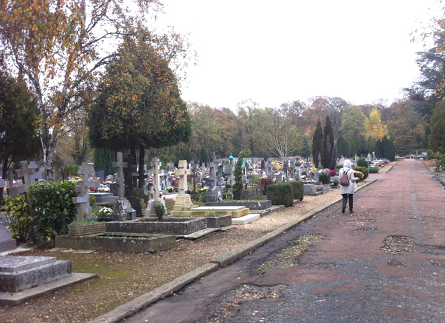 Visitor entering the cemetery with flowers