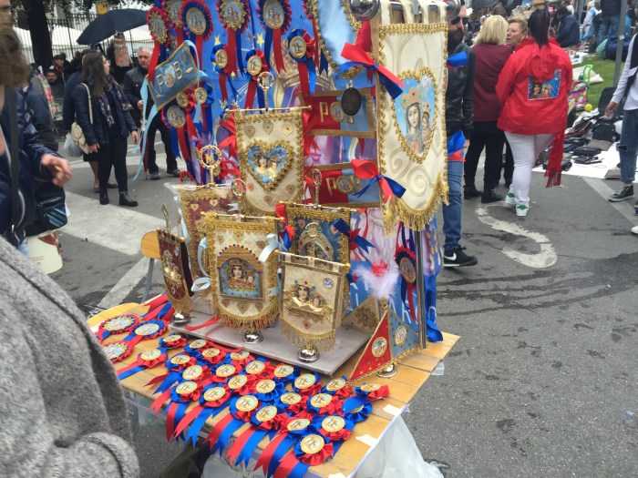 Rosettes and miniature banners on sale outside the sanctuary
